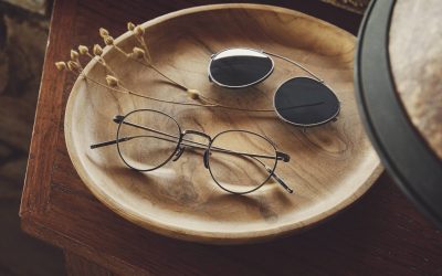 designer glasses and sunglasses on dresser